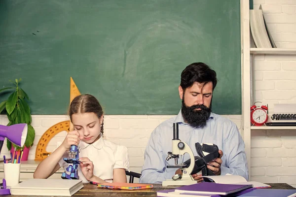 Education. biology chemistry lesson. education and knowledge. father and daughter study in classroom. bearded man teacher with small girl in classroom. back to school. math geometry — Stock Photo, Image