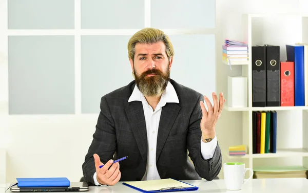 no mood to work. boss in workplace. modern office life. distant work while coronavirus quarantine. mature school teacher. Business-minded businessman. bearded man in formal jacket sit at table