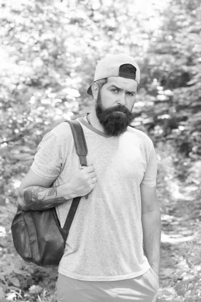 Relaxing hiking Experience. Bearded man carry backpack. ready for camping. male tourist wear cap. sport and fitness clothes. Confident and handsome brutal man. brutal caucasian hipster with moustache — Stock Photo, Image
