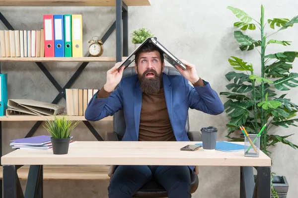 Hullu kauppias formalwear hold kannettavan tietokoneen pään päällä istuu pöydällä liike-elämän toimistossa, sähköinen kaupankäynti — kuvapankkivalokuva