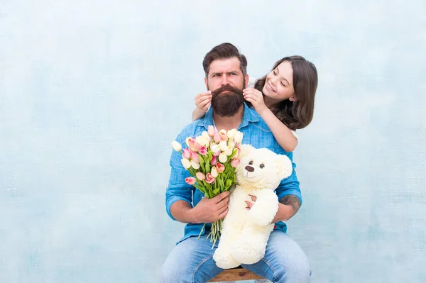 Happy family portrait with teddy bear. spring flower bouquet. womens day. prepare tulips for mothers day. daughter and father celebrate birthday. girl greeting dad with fathers day. family love — Stock Photo, Image