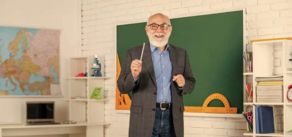 your future in your hands. learn geometry easily. become good at geometry. senior man teacher at blackboard. bearded tutor in glasses near geography map. back to school. lesson in classroom