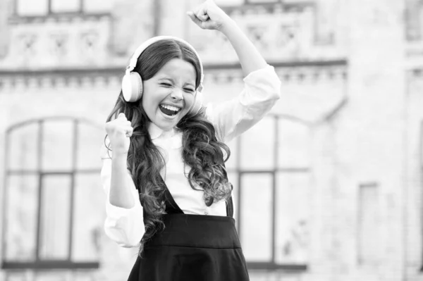 My perfect day. childhood happiness. kid in digital earphones. small student girl listen music outdoor. back to school. small girl looking smart and intelligent. happy schoolgirl in stylish uniform — Stock Photo, Image