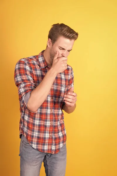 sleepy man on yellow background. sexy unshaven man. feeling tired in morning. barbershop salon. man in casual checkered shirt. handsome guy yawning. male beauty standard