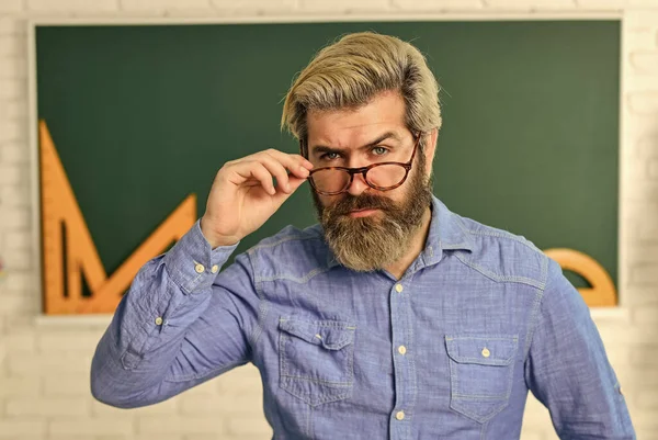 serious bearded teacher in glasses. back to school. develop logic and creativity. start the brain engine. physics research. math teacher at blackboard. education. exact sciences