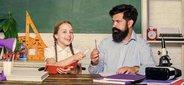Interesting book for children. daughter study with father. Teachers day. knowledge day. Home schooling. back to school. education child development. bearded man teacher with small girl in classroom — Stock Photo, Image