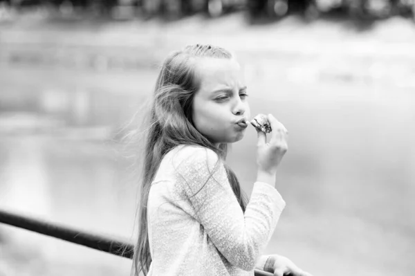 Enjoying every bite. Kid girl eat cookie. Health and dieting concept. Dieting counting calorie. Break her diet for sweets. Outdoors snack. Delicious cookie healthy snack. Sweet cookie pure enjoyment — Stock Photo, Image