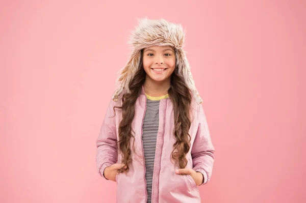 Calor de inverno. moda infantil. Menina da moda olhar como hipster. acessório chapéu earflap pele. chapéu de inverno menina pequena. Criança feliz pano de fundo rosa. roupas quentes para a estação fria. Estilo outono. Actividade infantil — Fotografia de Stock