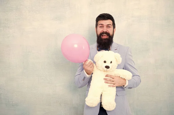 Womens day. Greetings 8 march. Stereotypical gifts. Valentines day. Romantic man with teddy bear and air balloon waiting girlfriend. Romantic gift. Macho ready romantic date. Man wear tuxedo bow tie — Stock Photo, Image