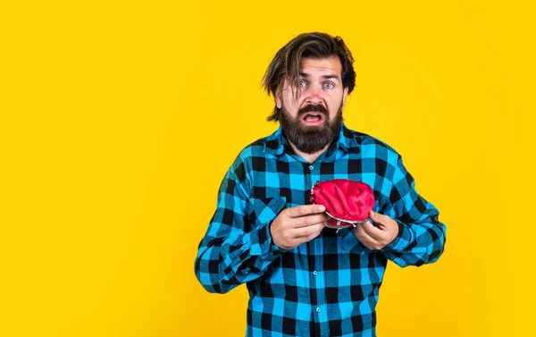 unhappy man hold purse. poor man need some money. loan in crises. have money saving. ready to go shopping. bearded hipster in checkered shirt with wallet. concept of finance and economy. copy space