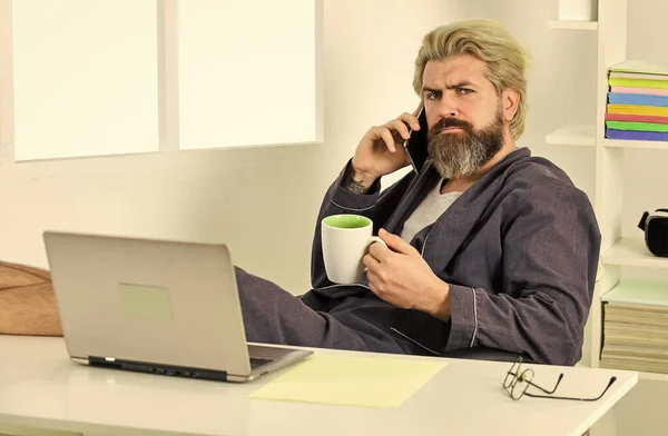Sharing fresh ideas. relaxed businessman in home office. online agile business. man using laptop indoor. bearded man looking at his laptop screen. making business at home. e-commerce and shopping
