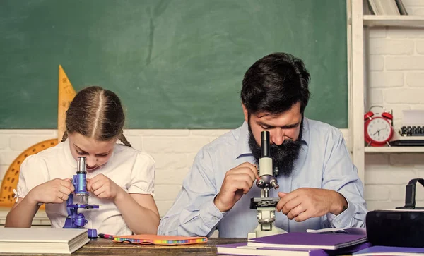 Modern education concept. back to school. math geometry. bearded man teacher with small girl in classroom. education and knowledge. biology chemistry lesson. father and daughter study in classroom — Stock Photo, Image