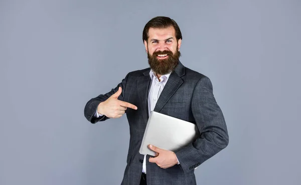 Jen se na to podívej. mužský zaměstnanec, který má finanční zprávu a zkoumá kopracovní prostor na notebooku. nové technologie v moderním byznysu. šťastný kavkazský vousatý hipster s počítačem — Stock fotografie