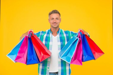 Elinde paketler olan mutlu yakışıklı bir adam. Tatil hazırlığı, hediye alışverişi.