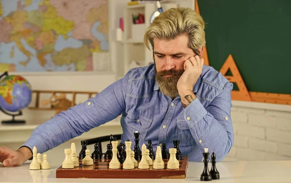 for all levels and ages. playing board game with friend. moving piece during chess tournament. moving pieces on chess board. man hold chess piece. Concentrated man developing chess strategy