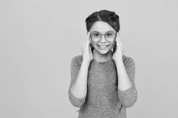 Eye accessory sure to please. Happy girl wear glasses yellow background. Fashion accessory. Designer eyewear. Glasses on sale. Buy optical frames. Trendy accessory isnt actually accessory, copy space — Stock Photo, Image