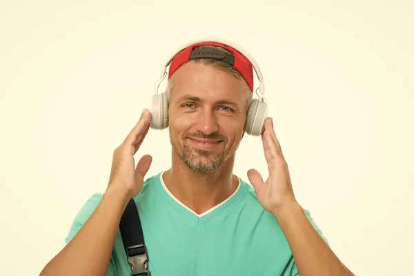Це важлива лише музика. Щасливий чоловік слухає музику ізольовано на білому. Красивий хлопець носить навушники, які грають музику. Нова технологія. Сучасне життя. Музика допомагає мені втекти від реальності, в якій я живу — стокове фото