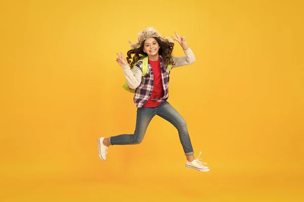 Captured in motion. Winter season concept. Kid girl wear hat with ear flaps. Winter vacations. Winter events at school. Winter entertainment and activities. Child schoolgirl soft hat enjoy season