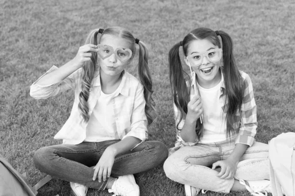 Enjoying playtime. back to school. literature for girls. do homework together. find something interesting in book. making notes. spend free time with party glasses. small kid friends relax on grass — Stock Photo, Image