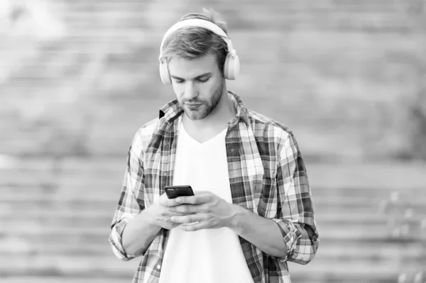 Busy man wireless headphones use smartphone, mobile internet concept