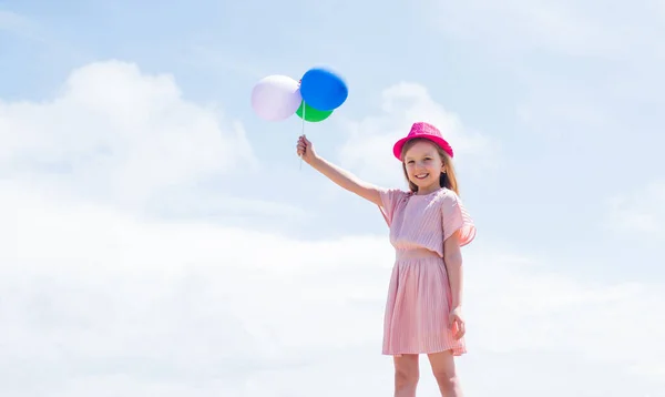happy childhood. cute child on sky background with balloons. spring season weather. summer holiday and vacation. freedom. beautiful teen girl with hat. kid fashion style. female natural beauty