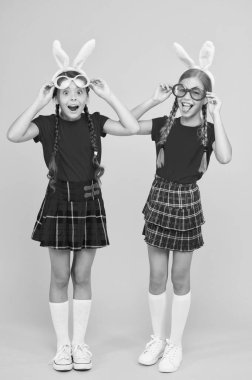 Küçük okul kızları uzun tavşan kulakları. Geleneksel Paskalya oyunları. Kültür ve gümrük kavramı. Bahar tatili. Tavşan kulaklı çocuklar. Okul arkadaşlarınla Paskalya 'yı kutla. Paskalya hazırlıkları