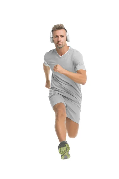 Motivational song. Man sportsman running with headphones. Runner handsome strong guy in motion isolated on white. Music fuel for workout training. Run faster. Running sport. Keep running every day. — Stock Photo, Image