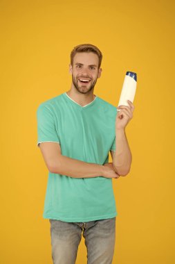 Yakışıklı adam şampuan şişesini tut. Sakallı adam jel tüpü tut. Berber dükkanı bakımı. Profesyonel berber. Banyo ya da duş için vücut bakım ürünleri. Saç bakımı. Sağlık ve sağlık hizmetleri. Erkek kozmetikleri
