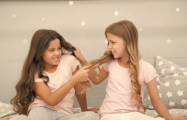 Unhand my hair. Naughty children pull on hair. Beauty look of little girls. Hair salon. Home clothing and leisure wear. Haidressing and styling. Because its my hair — Stock Photo, Image