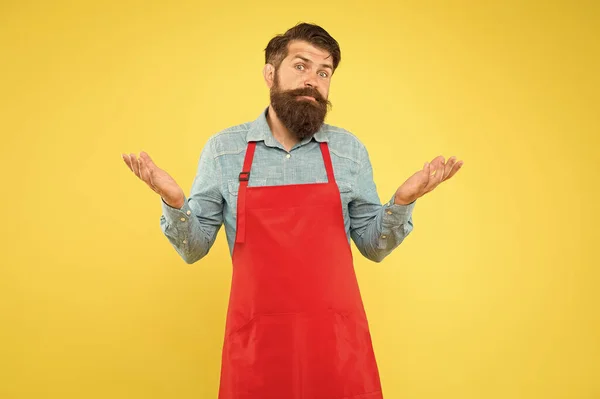 Femme de ménage masculine confuse. Propriétaire d'un petit magasin. assistant de magasin mature. Chef professionnel en tablier rouge. Le personnel du restaurant voulait. cuisiner est un passe-temps. homme barbu en uniforme de cuisinier. Expert culinaire — Photo