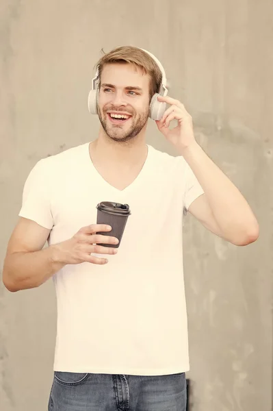 Skip track. Coffee consumption makes him happier. Handsome man drink coffee to go paper cup. Cafe concept. Coffee shop. Guy enjoy fresh hot brewed coffee. Daily caffeine amount. Walking with music — Stock Photo, Image