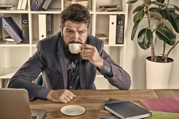 Müder Mann trinkt Kaffee. brauchen mehr Energie. Frühaufsteher trinken. modernes Büroleben. Reifer Geschäftsmann am Arbeitsplatz. Erschöpft und überarbeitet. ceo am Tisch sitzen mit Notebook und Laptop — Stockfoto