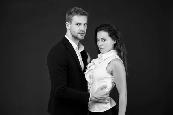 Sexy business couple of man and woman embrace on black background represent sexual harassment, couple in love — Stock Photo, Image