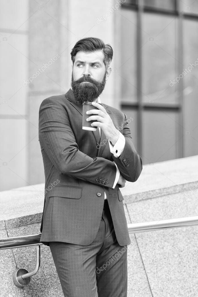 Successful man owner of business company has coffee break. handsome guy wear expensive office jacket. morning cheerfulness with coffee. Confident male executive director with coffee to go