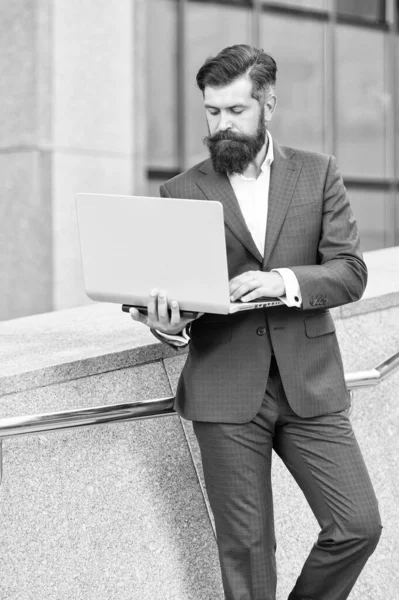 Never out of style. digital technology in modern life. good internet connection. confident businessman hold notebook. bearded businessman reply to e-mail. formal man in office suit distant working