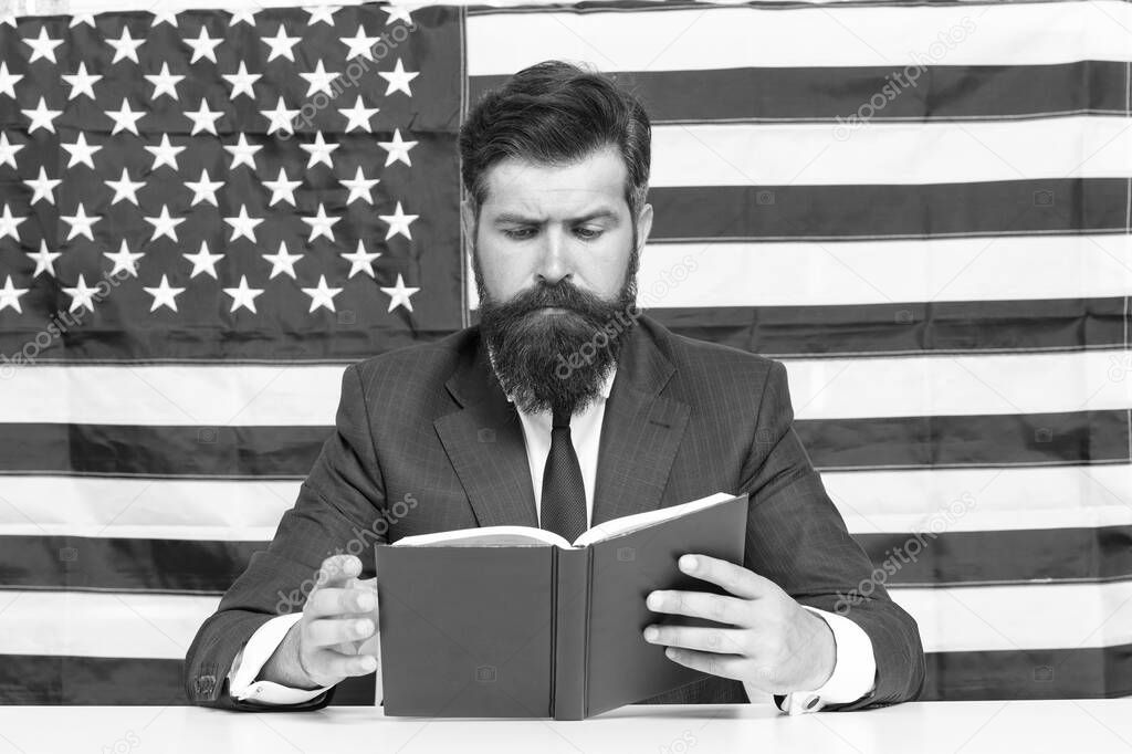 Hipster man reading book USA flag background, university lecturer concept