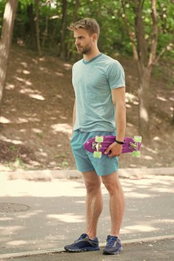 Yaz hobisi. Eğlence olsun diye kaykay sürüyorum. Özgürlük ve azim. Atletizm sporcusu panoyu açık havada tutuyor. Kaykay sporu ve aktivite. Ulaşım ve hobi. Sokak ve park kaykayı