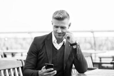 İnternet bağlantısı. Kullanışlı bir uygulama. İş iletişimi. Mesaj gönder. Taşınabilir yaşam tarzı. Çevrimiçi iletişim. Modern iletişim. İş adamı cep telefonunu tutar. Telefonu olan yakışıklı bir adam.