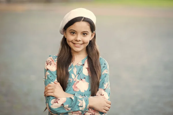 Create your style with us. Happy girl wear beret in fashion style. Little child with long hair grey background. Fashion and style. Beauty salon. French style inspiration