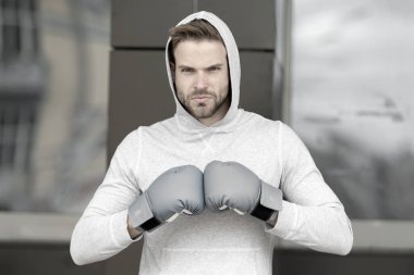 Dövüş konsepti Erkek boksör dövüşmeye hazır. Sporcu dövüş kulübünde boks eldiveni giyer. Dövüş başladı.