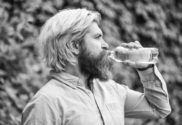 moisturize dry mouth. bearded mature man drinking some water. fresh and healthy water from bottle. healthcare and water balance concept. need to quench thirst. refresh in hot weather