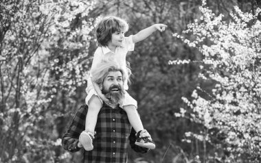 Mutlu bir aile. Küçük oğlum. Bahar yürüyüşü. Babalık. Babalar Günü. Doğada yaşayan küçük bir çocuk ve baba. Hipster ve küçük oğlu çiçek açan bahçede. Sakallı zalim adam, iyi baba. Baba ve oğul.