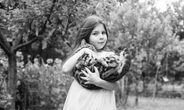 I love you. small girl hold cute cat in hands. kid love her pet. human and animals. love and care. fluffy cat in hand of pretty child. little beauty outdoor with pet. happy childhood. pet lover