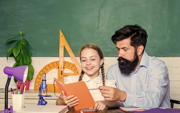 This is my book. education and knowledge. biology chemistry lesson. bearded man teacher with small girl in classroom. father and daughter study in classroom. back to school. math geometry — Stock Photo, Image