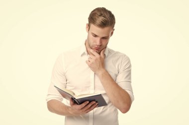 İlginç düşünceler. İş adamı kitabı tutuyor. Kitap okuyorum. Kitaptan ilham al. Ders notları olan üniversite erkek öğrencisi. Kendi kendine eğitim. Çalışmaya devam. Bilgi susuzluğu. Üniversite öğrencisi