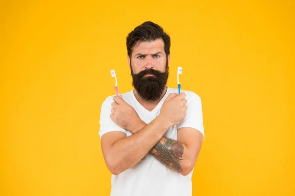 No toothache. Bearded man hold toothbrushes. Hipster with tooth brushes. Teeth care. Oral hygiene. Dental care. Fresh breath. Protecting teeth. Take care of your teeth