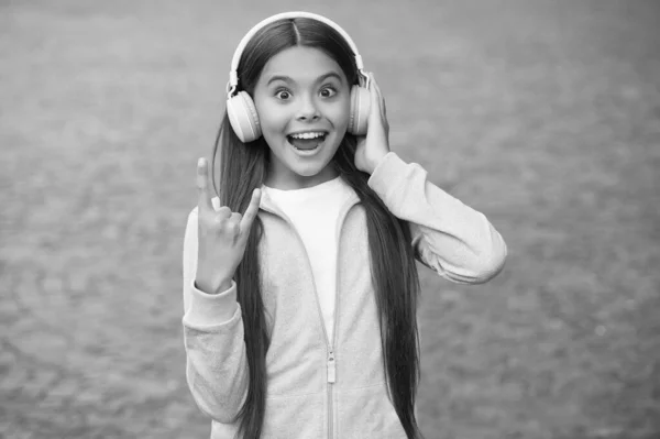 funny school child listen music or audio book in headphones for education and joy, modern life and fun