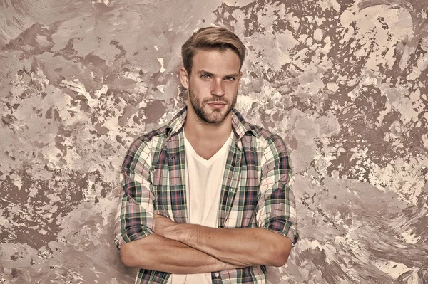 Style confidence. Confident guy. Guy keep arms crossed abstract background. Handsome guy in casual style. Unshaven guy wear plaid shirt. Fashion and style. Menswear store, vintage filter