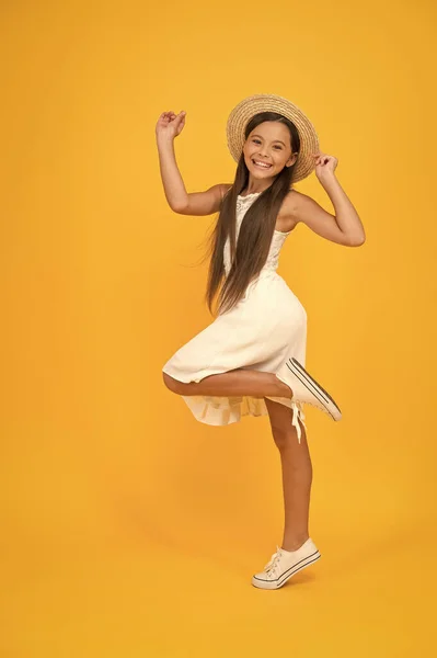 Lets have fun. small girl on vacation. rancho child in straw hat. little cutie on yellow background. happy childhood of positive girl. beauty. kid summer fashion. ready for beach party. holiday mood