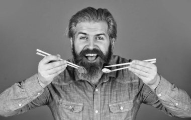 Suşi ya da sashimi ile servis edilen zencefil turşusu. Suşi ruloları. Japon mutfağı. Asya yemeği. Suşi rulosu. Adam suşi çubuğu yiyor. Doğu kültürü. Sakallı hippi rulo yiyor. Japon yemek servisi.